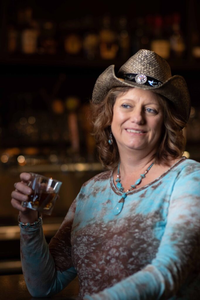 woman in cowboy hat bar side at blue tick diner